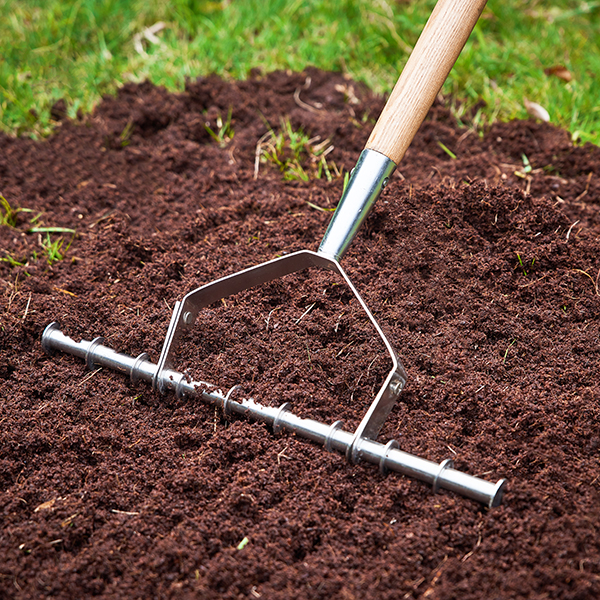 Stainless Steel Long Handled Scarifying Rake In-Use Image Stainless Steel Long Handled Scarifying Rake - Image 3